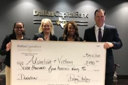 Dallas Capital presents check to Adventure & Victory